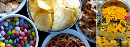 Candy, chips, pretzels and other processed snacks in bowls