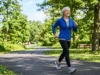 Adult over 60 walking briskly in a park for heart and healthy aging support